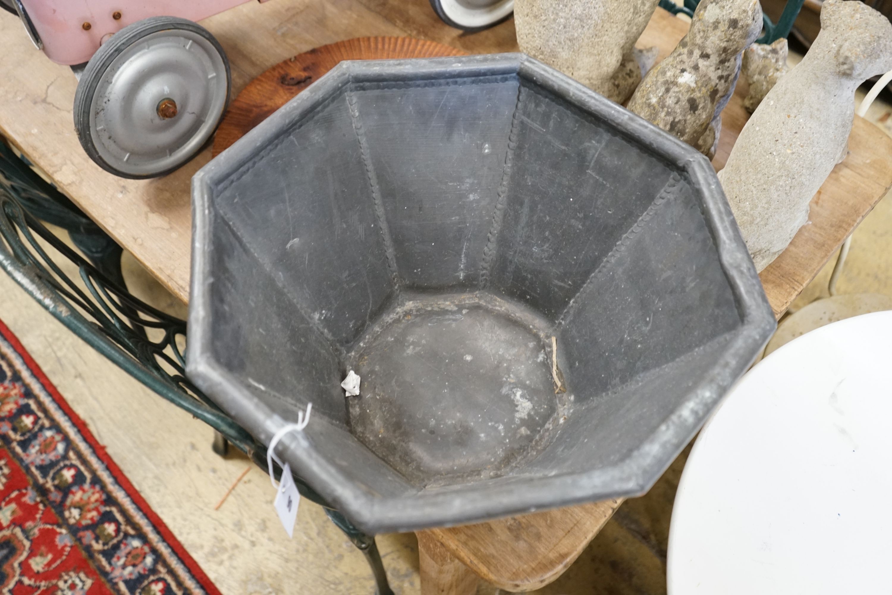 An octagonal lead garden planter, width 44cm, height 25cm